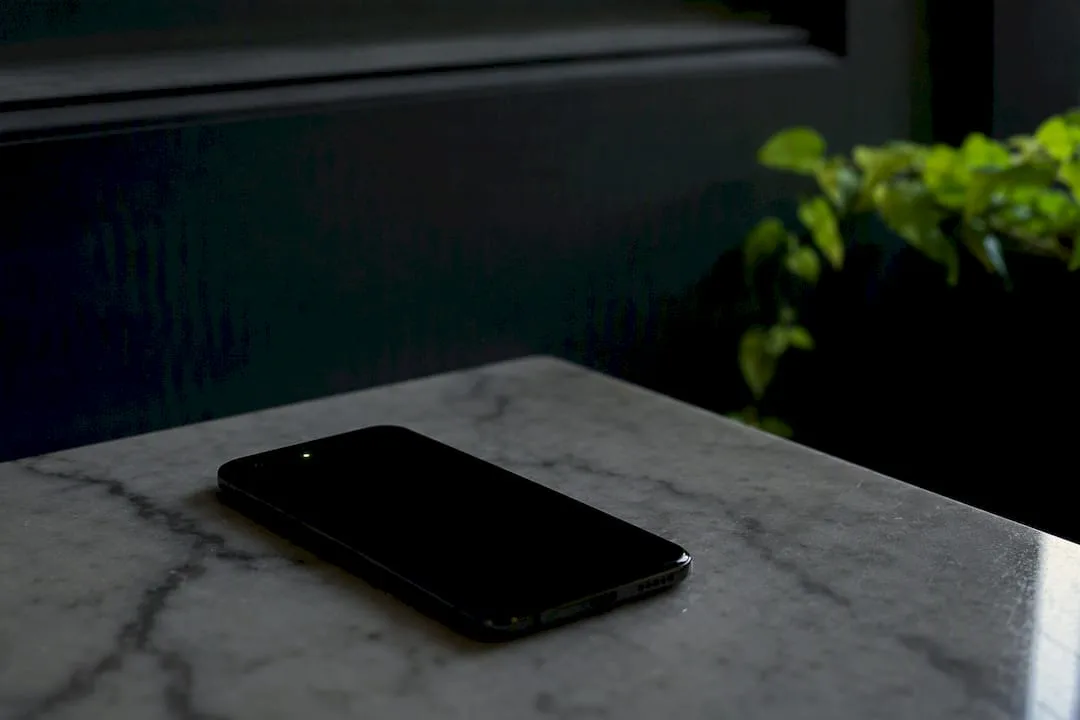 Smartphone with glowing message notification at night